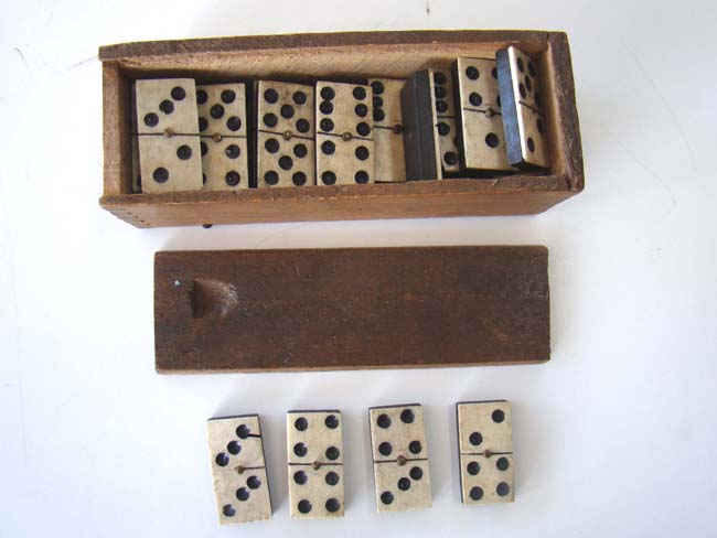 An early 19th century complete set of bone and ebony dominoes